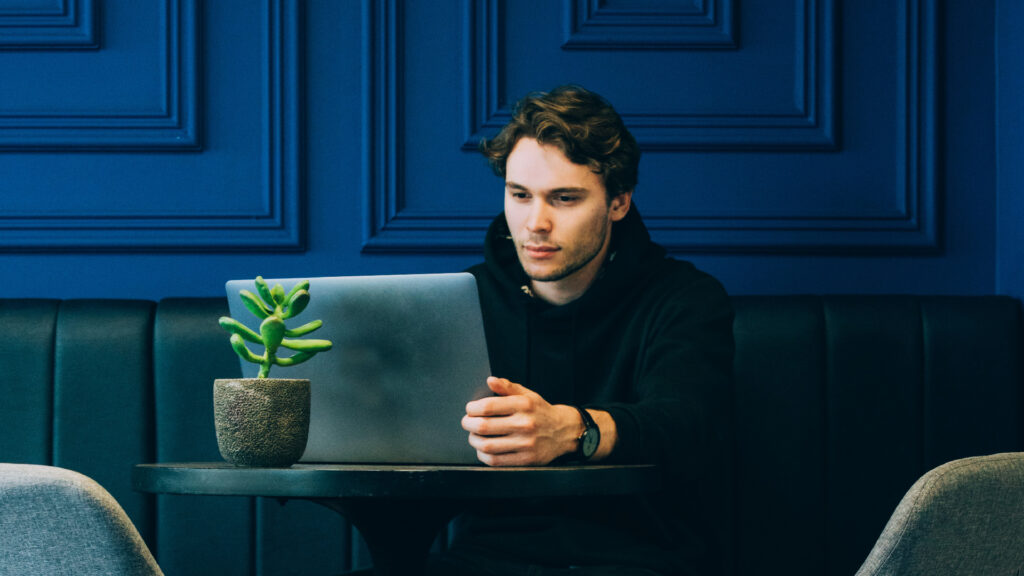 Man using a computer while working on UX copy